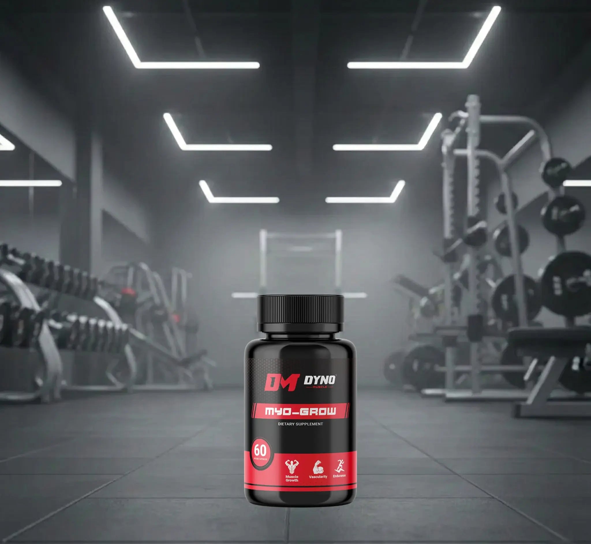 A professional studio shot of the Dyno-Muscle supplement line, featuring three black bottles labeled 'TESTO CHARGE,' 'MYO-GROW' (a dietary supplement for muscle growth), and 'HYPER-SHRED FAT BURNER.' The bottles are positioned on a dark gym floor with weights and fitness equipment visible in the blurred background under striking white lights.